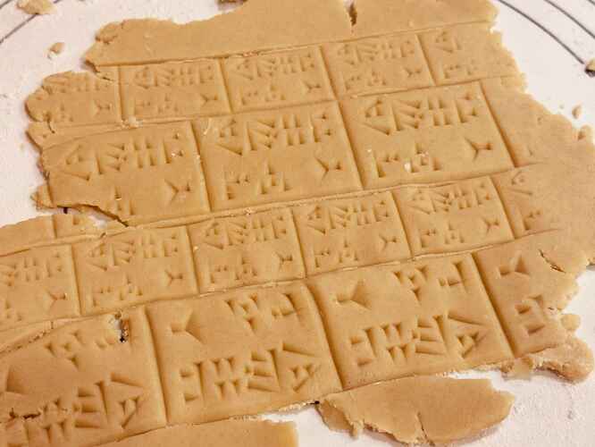 a sheet of dough covered in cuneiform