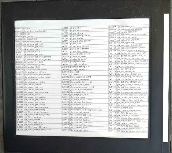 A transparent window pocket in the cover of a closed black binder shows a table of Glk Opcodes