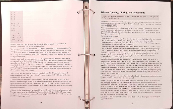 An open black binder shows pp. 24-25 of the black and white Glk Spec PDF that's the subject of this post