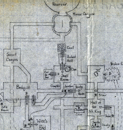 A section of a hand-drawn map on graph paper. The high constrast of the scan makes it look grimy. At the top, touching the top of the page, is a half-circle labeled "Reservoir". Below that is a rounded square labeled "Mirror Canyon". The walls of the Mirror Canyon, unlike the walls of other rooms, have marks that are reminiscent of stone blocks. A vertical line in the middle of the room indicates the mirror. The Mirror Canyon has east and west windows. The east window zigzags down and right to "Y2", which in turn connects to "Broken Rocks" and "Hall of the Mt. King". The west window bends left and down to "Secret Canyon", which leads SE to Bedquilt and S to something off the image. The south exit from Mirror Canyon turns left, to connect to Slab Room which is not in the image. In the center is the Shell Room / Arched Hall complex. There is no SW exit from the Hall of the Mt. King and no dragon room.